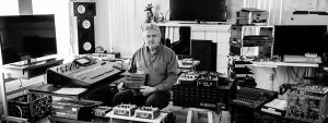 Allan Holdsworth sitting in studio full of gear